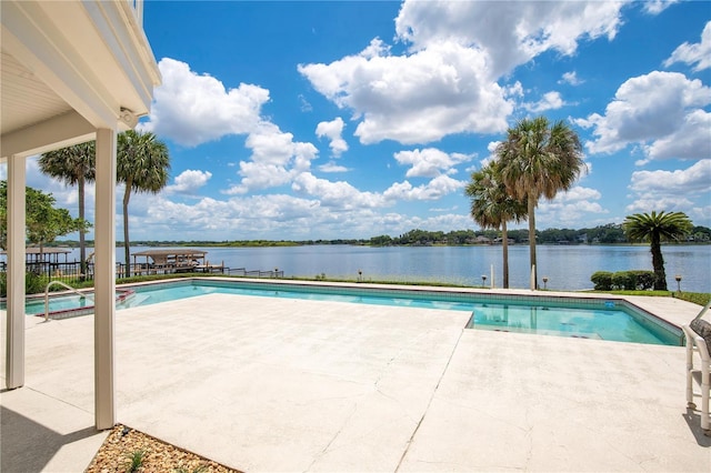 view of swimming pool featuring a water view, a fenced in pool, and a patio