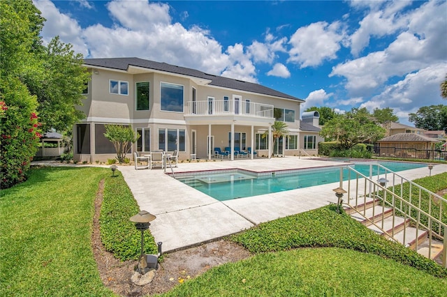 view of pool featuring a yard, a patio area, fence, and a fenced in pool