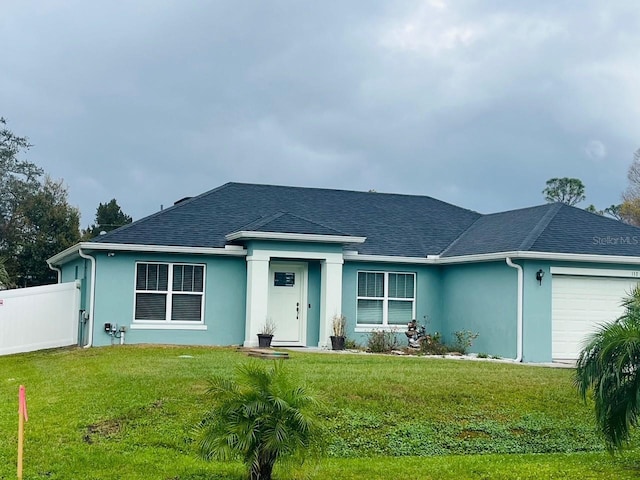 view of front of property with a garage and a front yard