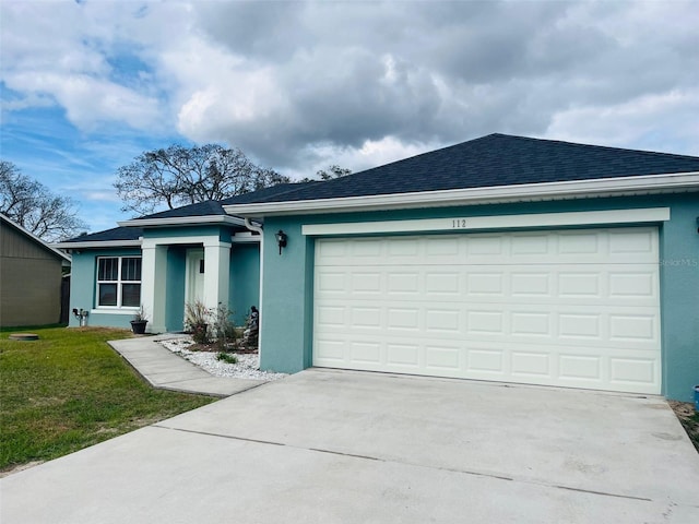 ranch-style house featuring a garage and a front yard