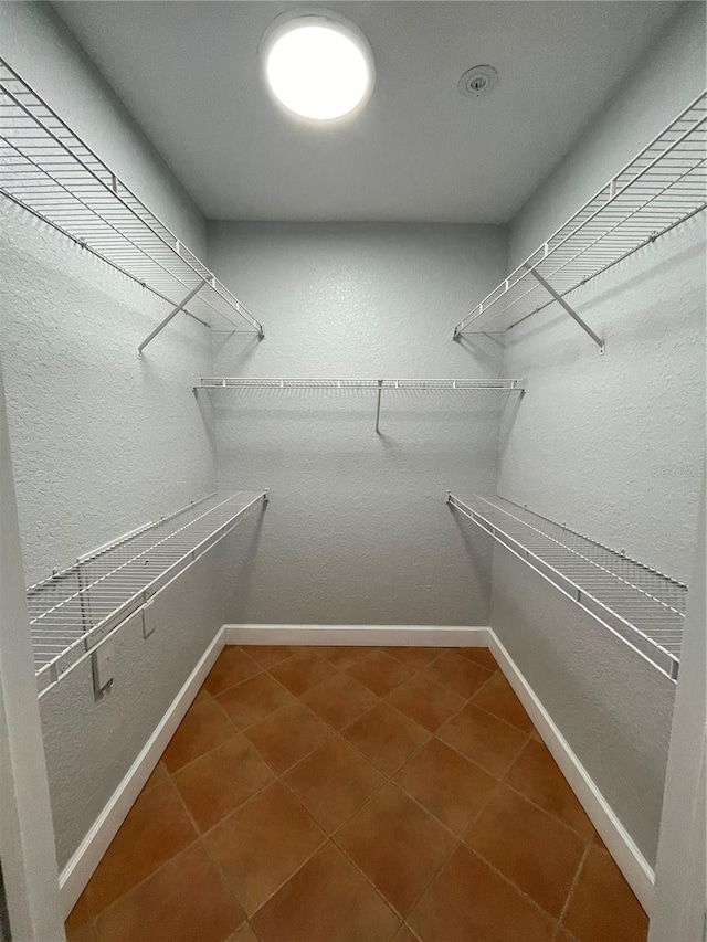 spacious closet featuring tile patterned floors