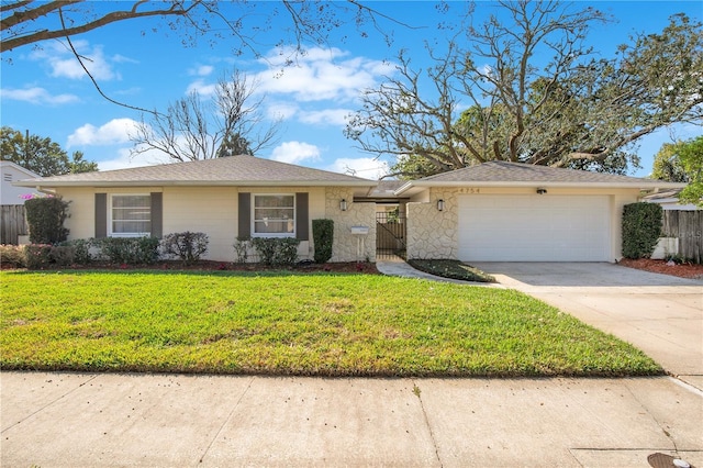 ranch-style home featuring a garage and a front lawn