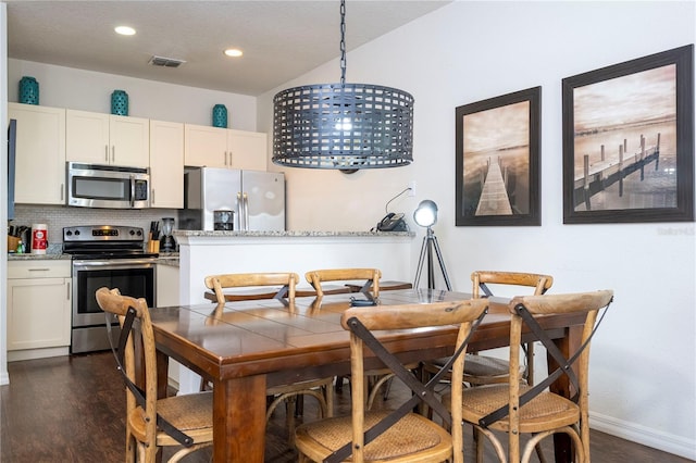 dining area featuring dark hardwood / wood-style flooring