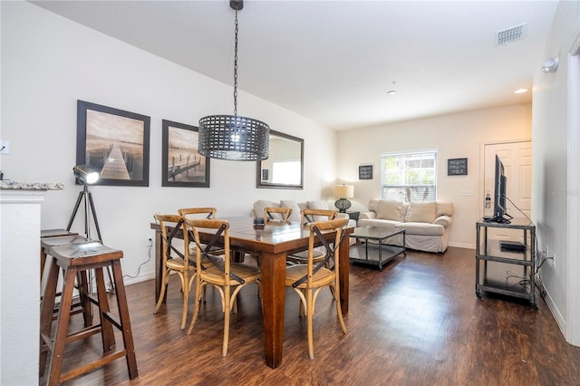 dining area featuring dark wood-type flooring