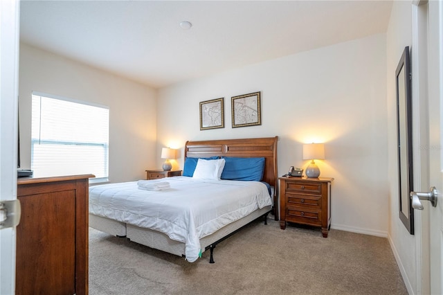 bedroom featuring light colored carpet