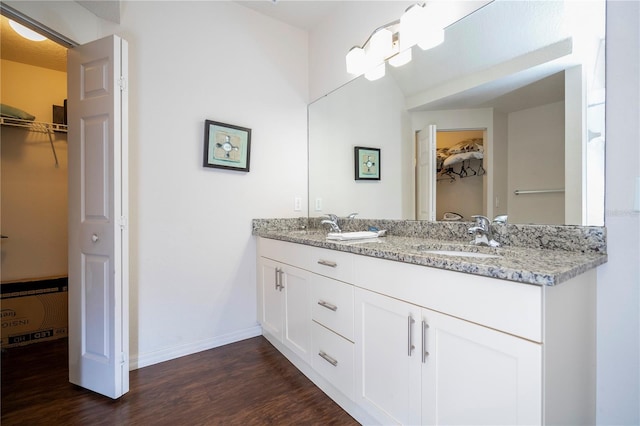 bathroom featuring vanity, a notable chandelier, and hardwood / wood-style flooring