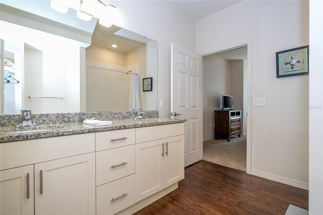 bathroom featuring wood-type flooring, vanity, and a shower with shower curtain