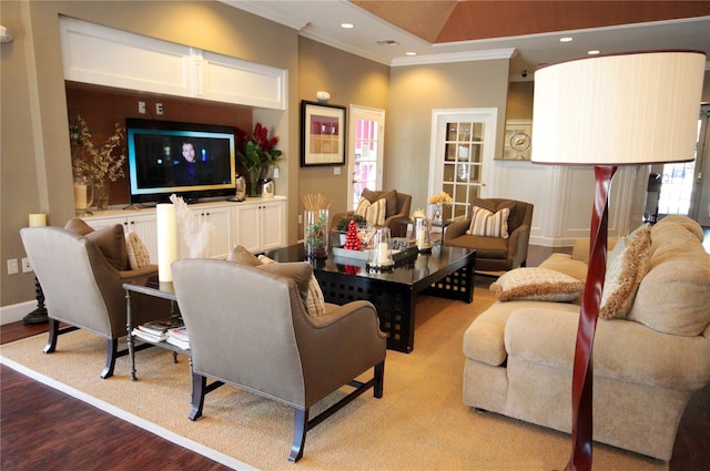 living room featuring crown molding and light hardwood / wood-style flooring