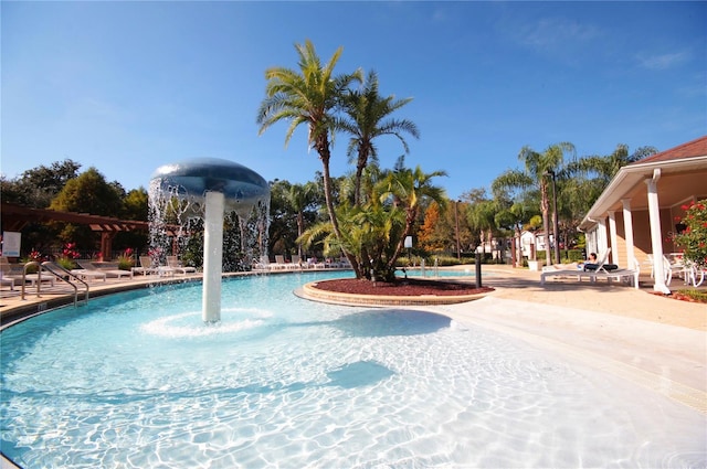 view of swimming pool featuring pool water feature and a patio area