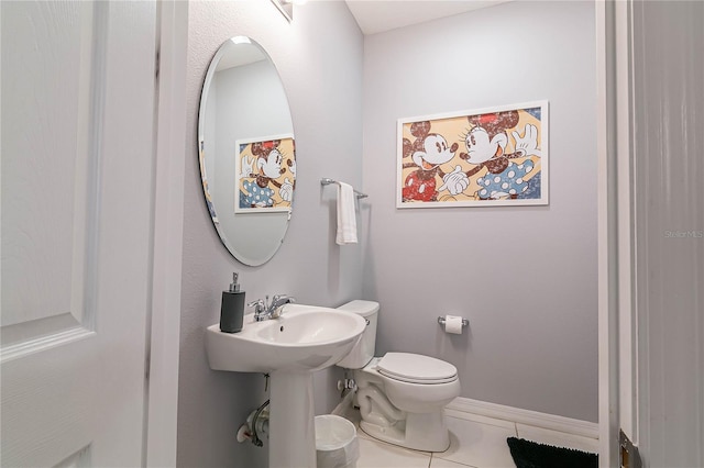 bathroom featuring sink, toilet, and tile patterned floors