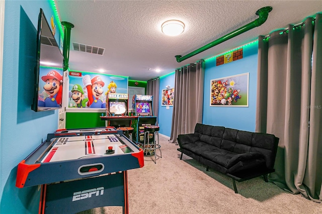 playroom with carpet and a textured ceiling