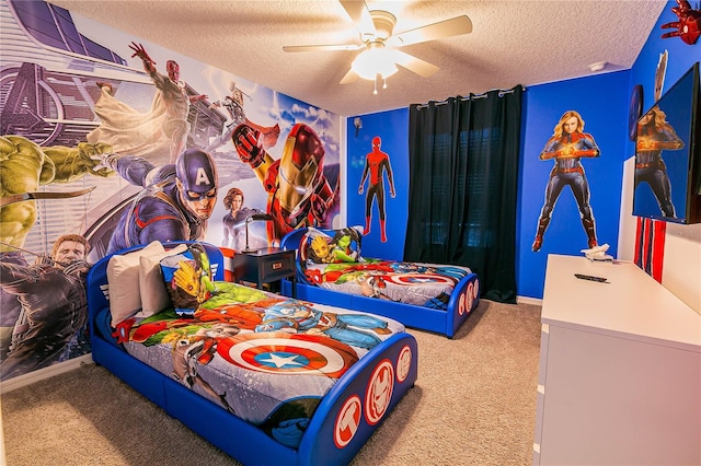 carpeted bedroom featuring ceiling fan and a textured ceiling