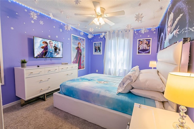 bedroom with a textured ceiling, light colored carpet, and ceiling fan