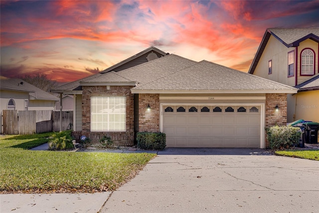 view of front facade with a garage and a yard