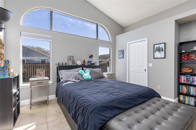 bedroom featuring light tile patterned flooring and vaulted ceiling