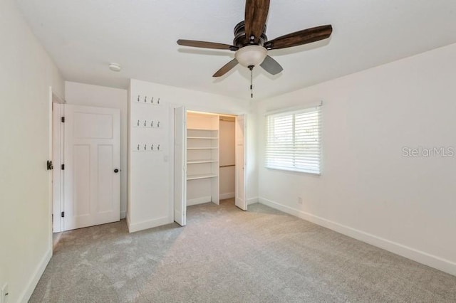 unfurnished bedroom featuring a ceiling fan, carpet flooring, and baseboards