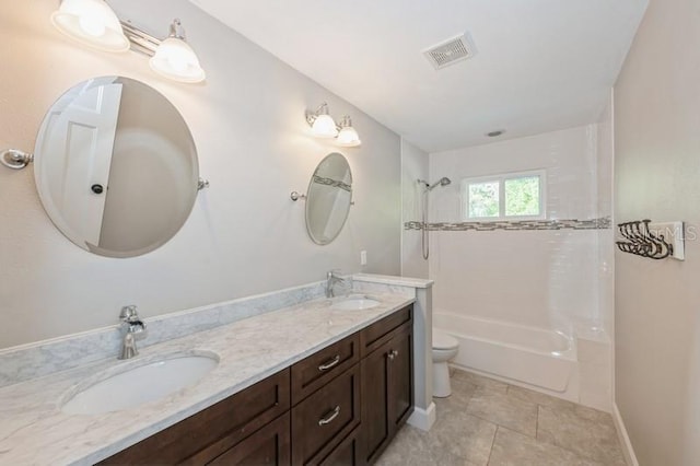 bathroom with visible vents, a sink, toilet, and double vanity