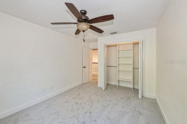 unfurnished bedroom featuring visible vents, baseboards, ceiling fan, carpet flooring, and a closet