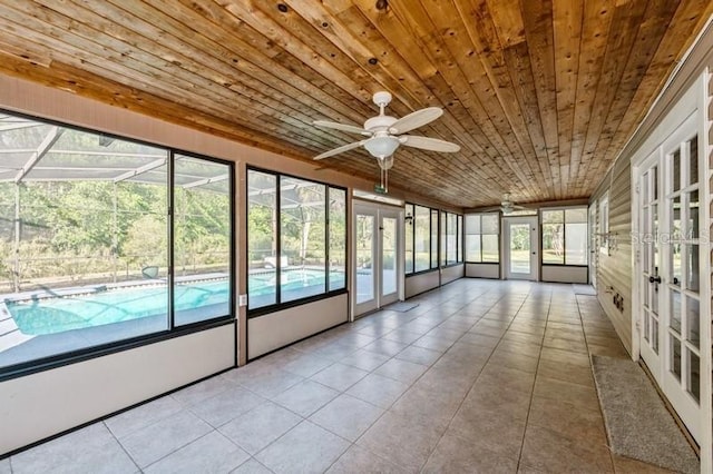 unfurnished sunroom with ceiling fan, french doors, and wood ceiling