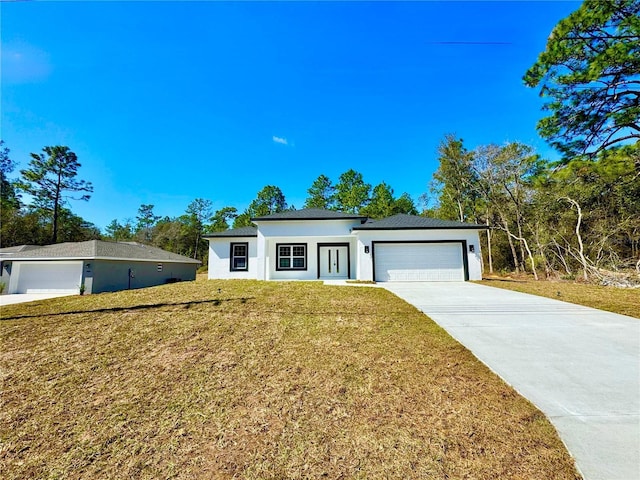 view of front of property featuring a garage and a front lawn