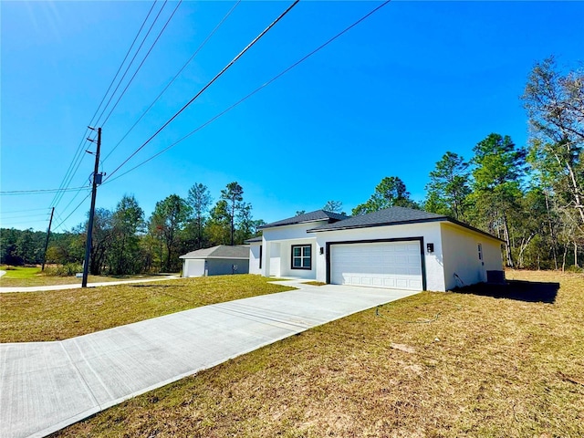 ranch-style house featuring a front lawn and a garage