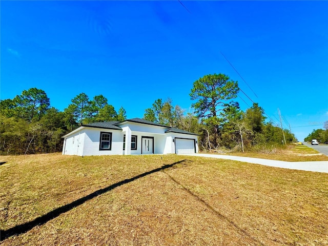 exterior space featuring a front lawn and a garage