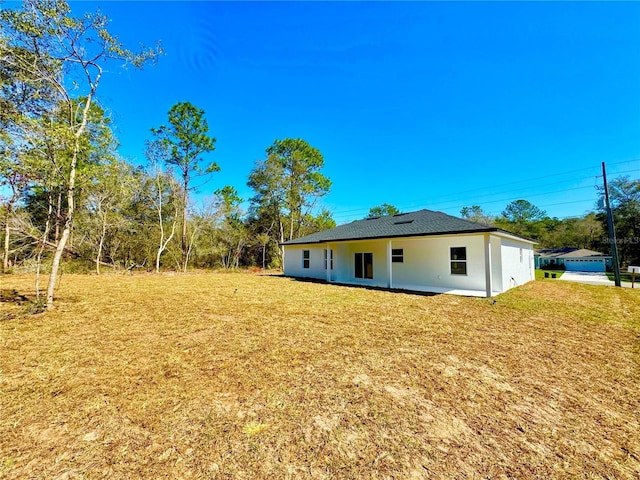 back of property with a lawn