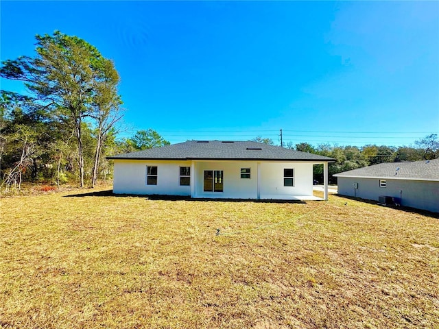 back of house featuring a yard