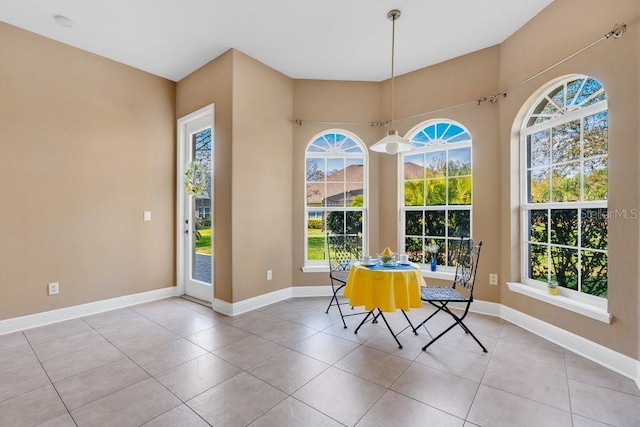 tiled dining room with baseboards