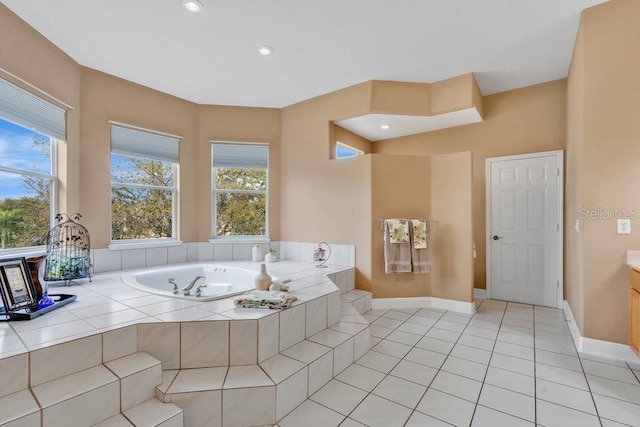 bathroom featuring tile patterned floors, baseboards, and a garden tub