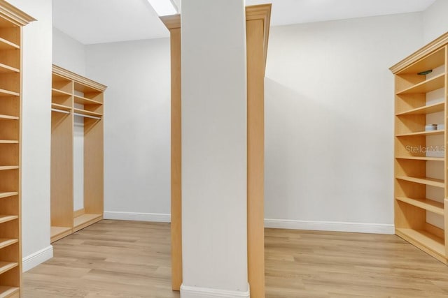 walk in closet featuring wood finished floors