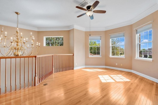 unfurnished room with a wealth of natural light, baseboards, hardwood / wood-style floors, and crown molding