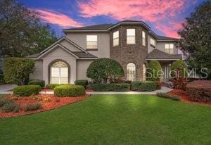 view of front facade featuring a lawn and stucco siding