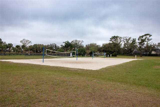 view of property's community with volleyball court and a lawn