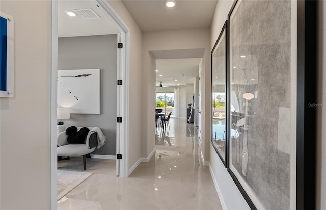 corridor featuring light tile patterned floors