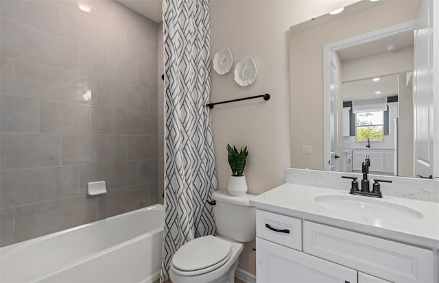 full bathroom with shower / bath combination with curtain, vanity, and toilet