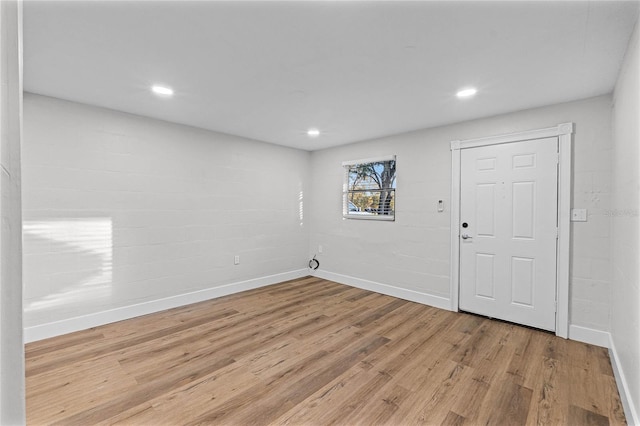 spare room with light wood-type flooring, baseboards, and recessed lighting