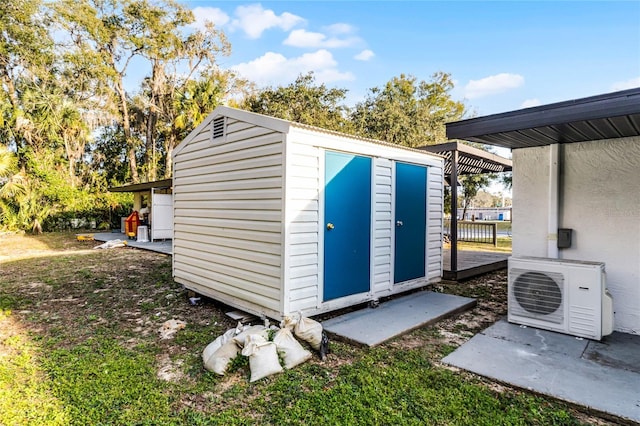 view of shed with ac unit and a pergola