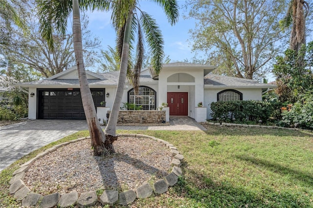 view of front of home with a garage and a front yard