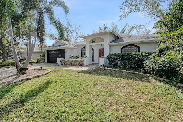 view of front of home with a garage and a front lawn