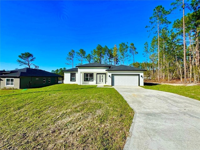 view of front of home with a front yard and a garage