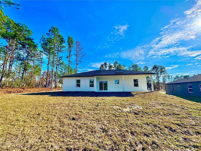 rear view of property with a yard