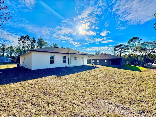 back of house with a lawn