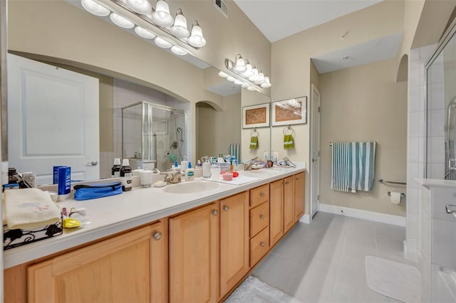 bathroom with vanity, tile patterned flooring, and a shower with shower door