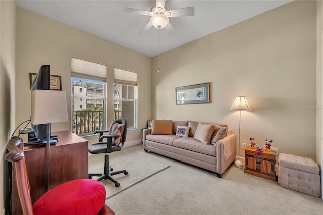 office space with ceiling fan and light colored carpet