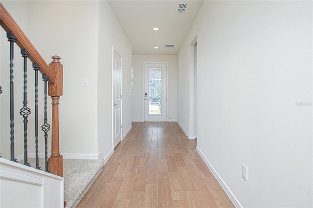 doorway featuring recessed lighting, baseboards, visible vents, and light wood finished floors