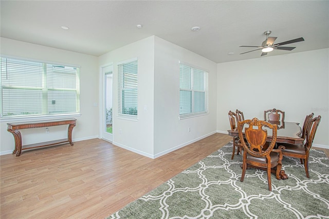 dining space featuring baseboards and wood finished floors