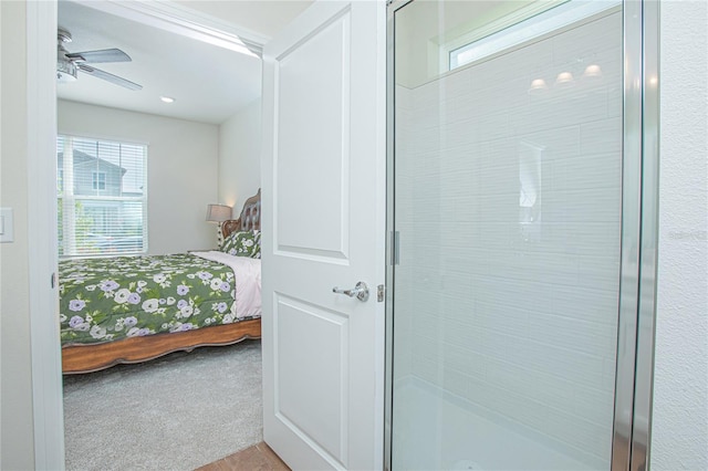 full bath featuring a ceiling fan, a stall shower, and ensuite bath