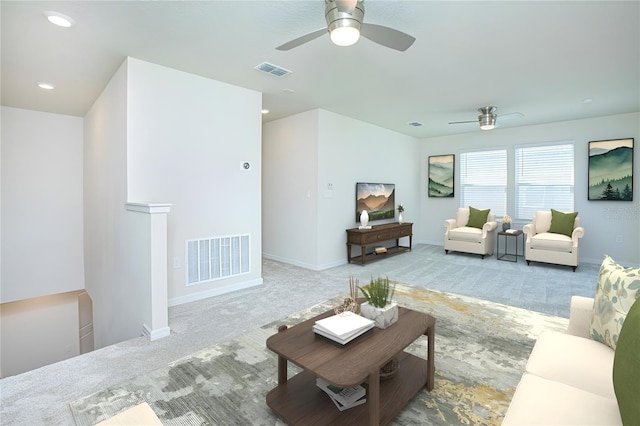 carpeted living room with baseboards, visible vents, and recessed lighting