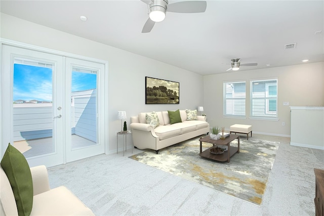 carpeted living room featuring a ceiling fan, french doors, visible vents, and baseboards